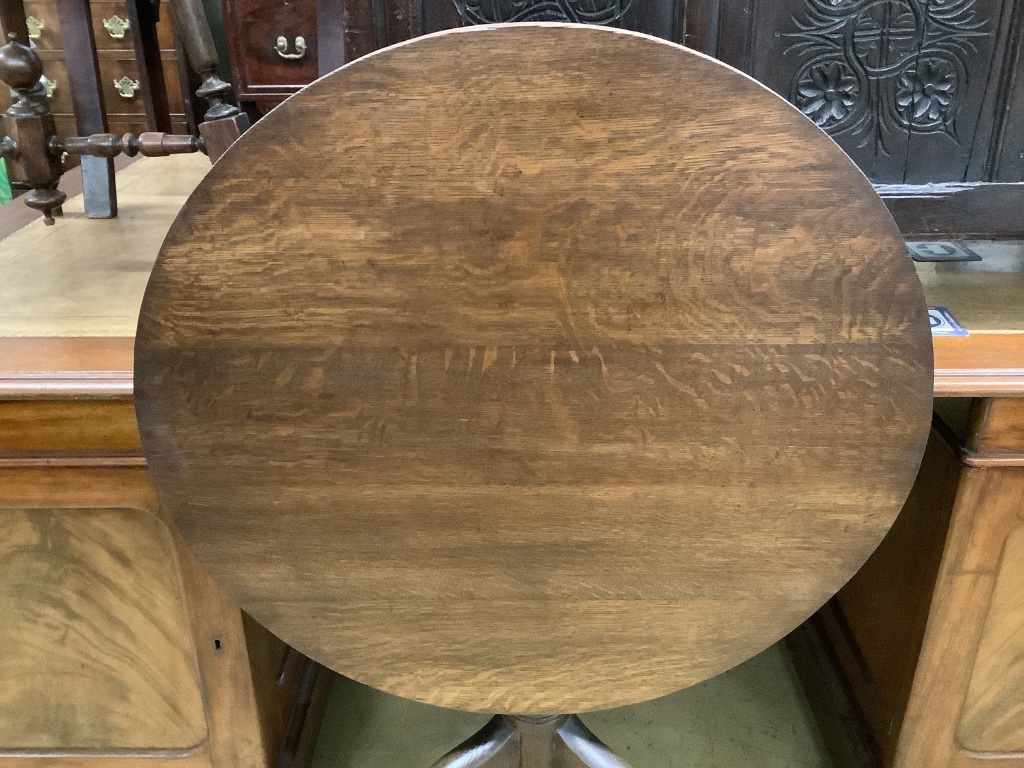 A George III oak circular tilt top tea table, diameter 75cm height 70cm